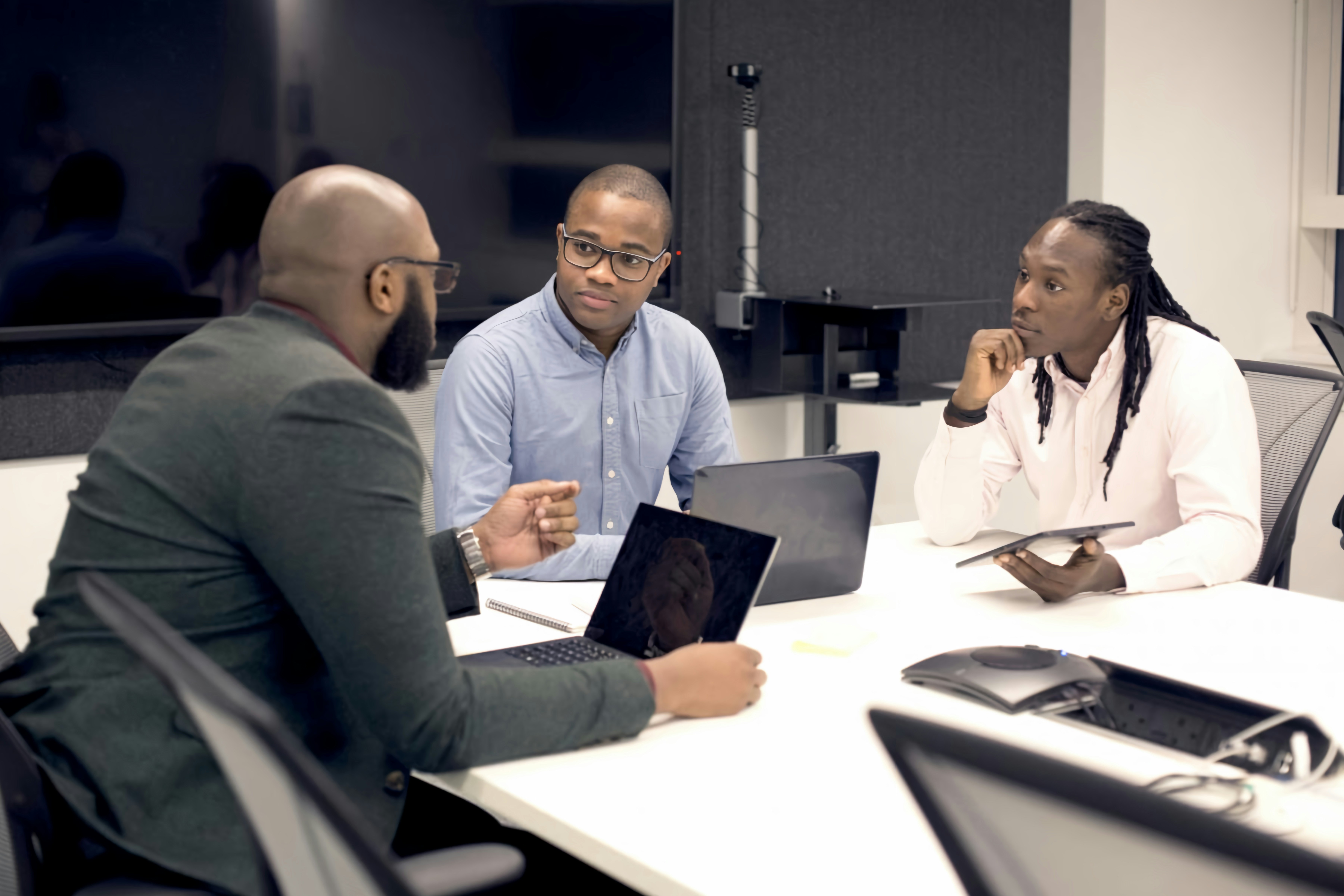 Small team discussing strategy in a meeting room
